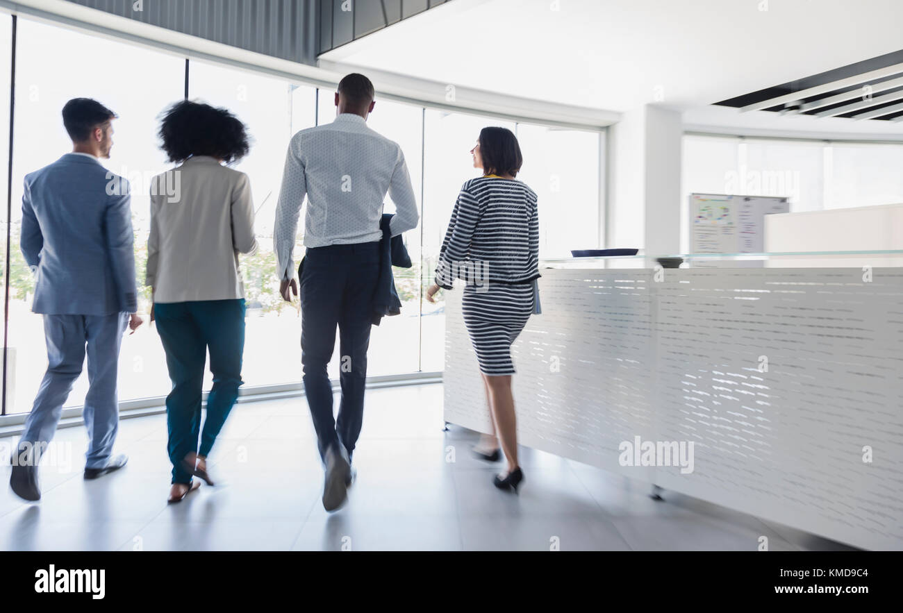 Business people walking in office lobby Stock Photo