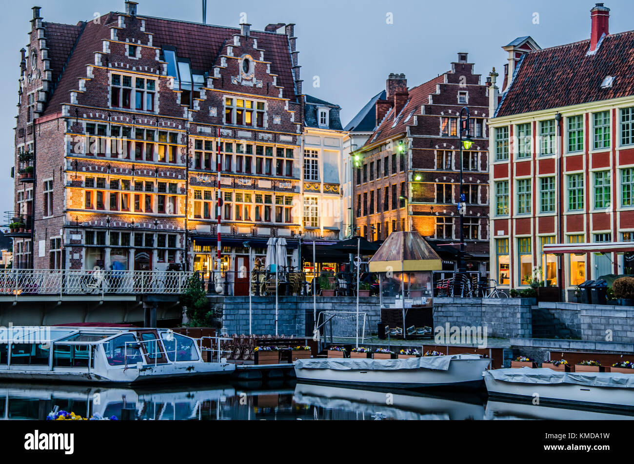 Boats pier and old buildings with its bars in ghent belgium Stock Photo
