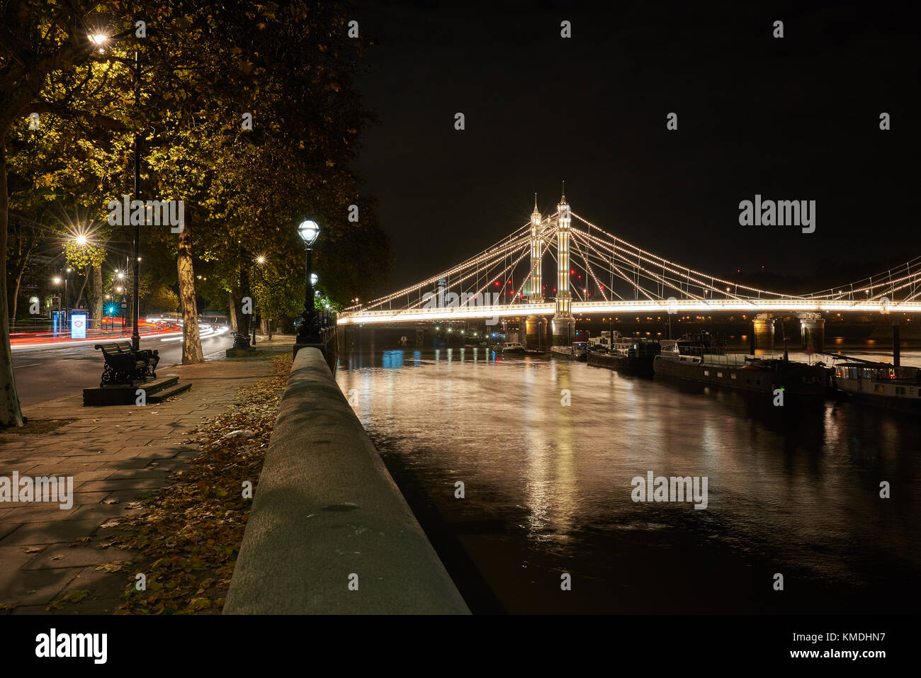 albert bridge in Chelsea looking East at night with Chelsea Embankment Stock Photo