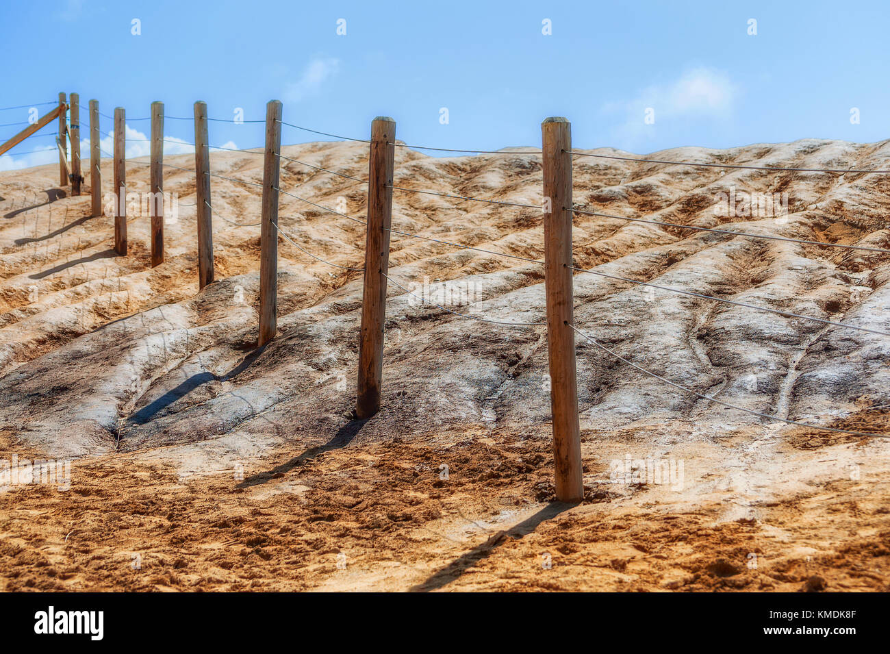 Cape Kiwanda safety boundary fence stretches upward seemingly towards the sky in the minimalist image Stock Photo