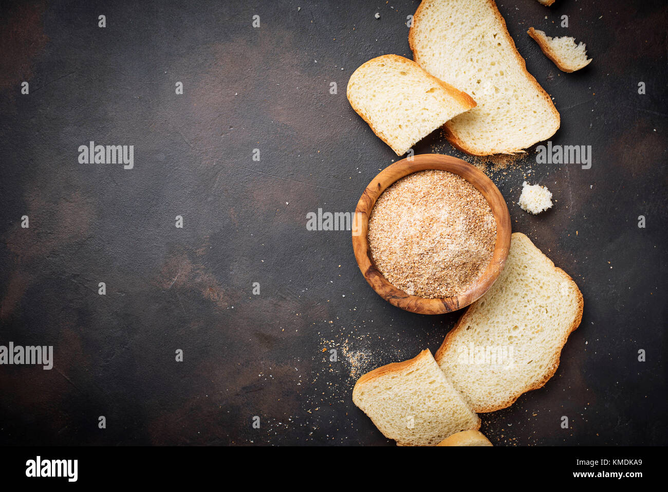 Bowl of breadcrumbs and slices of a loaf Stock Photo
