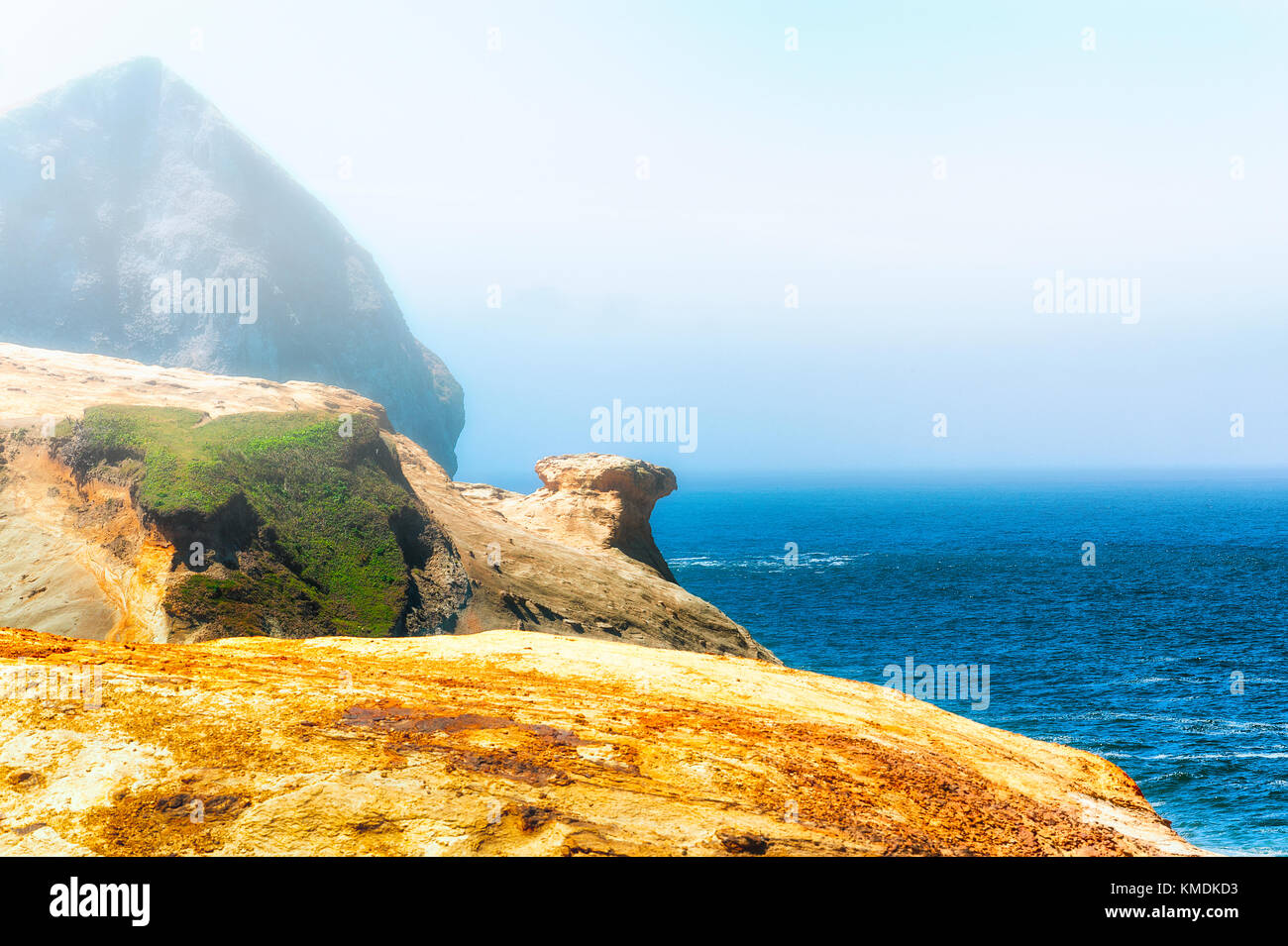 A view of the Pacific Ocean and the top of Haystack Rock from on top of the sandstone cliffs of Cape Kiwanda in Pacific City on the Oregon Coast Stock Photo