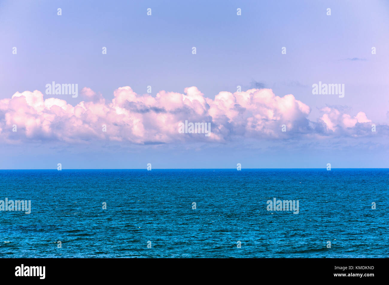A simplistic view of the Pacific Ocean and the sky with clouds. Stock Photo