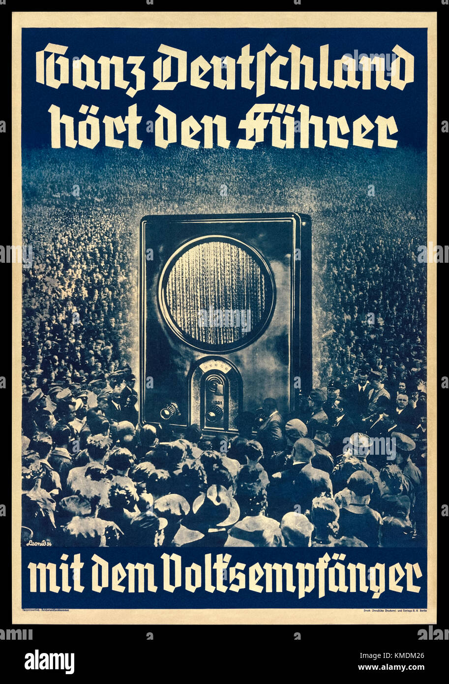 “Ganz Deutschland hört den Führer mit dem Volksempfänger” (All over Germany hear the leader with the people's receiver) 1936 Nazi Germany propaganda poster featuring a photograph of a crowd of Germans at a Nuremberg Rally surrounding an oversized Volksempfänger VE301 radio receiver which was developed on instruction by Propaganda Minister Joseph Goebbels and when on sale in 1933. See more information below. Stock Photo