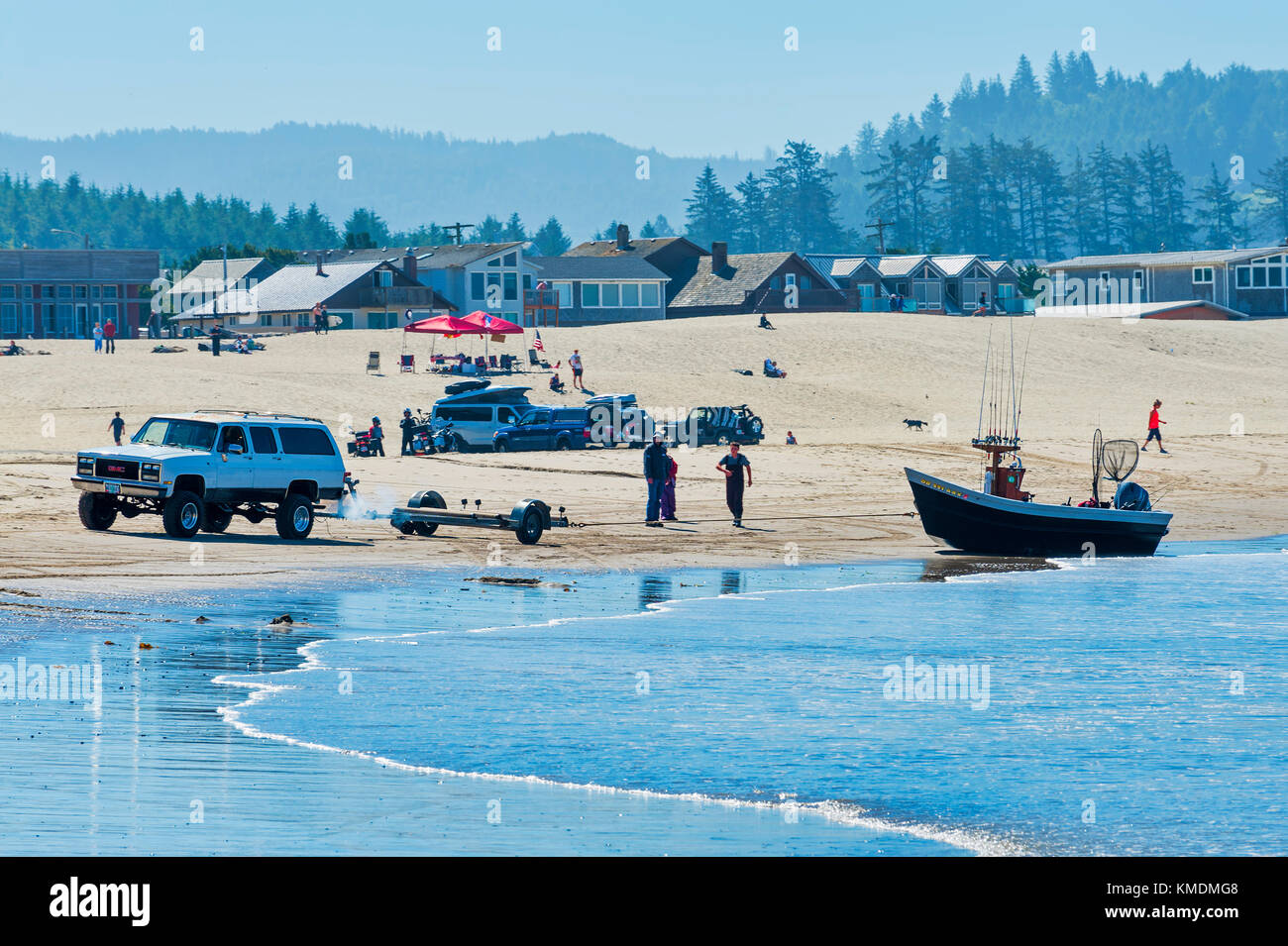 Pacific City, Oregon, USA July 2, 2015 A 4wheel SUV backs a boat trailer up to his dory boat