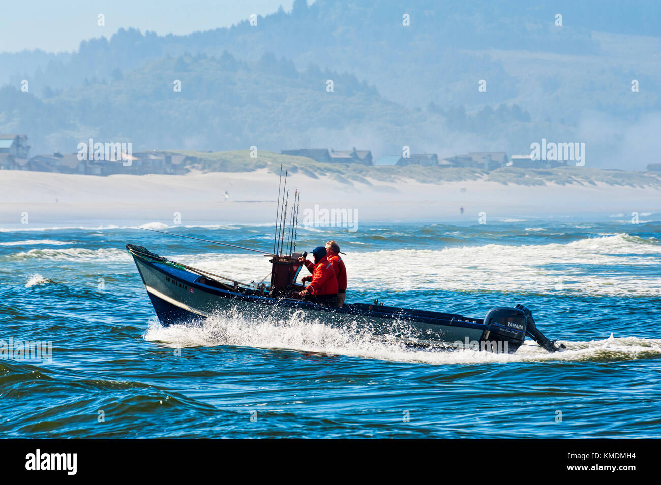 Pacific City, Oregon, USA - July 2, 2015: A dory boat coming in to landing on the beach at Cape Kiwanda, Pacific City, Oregon Stock Photo