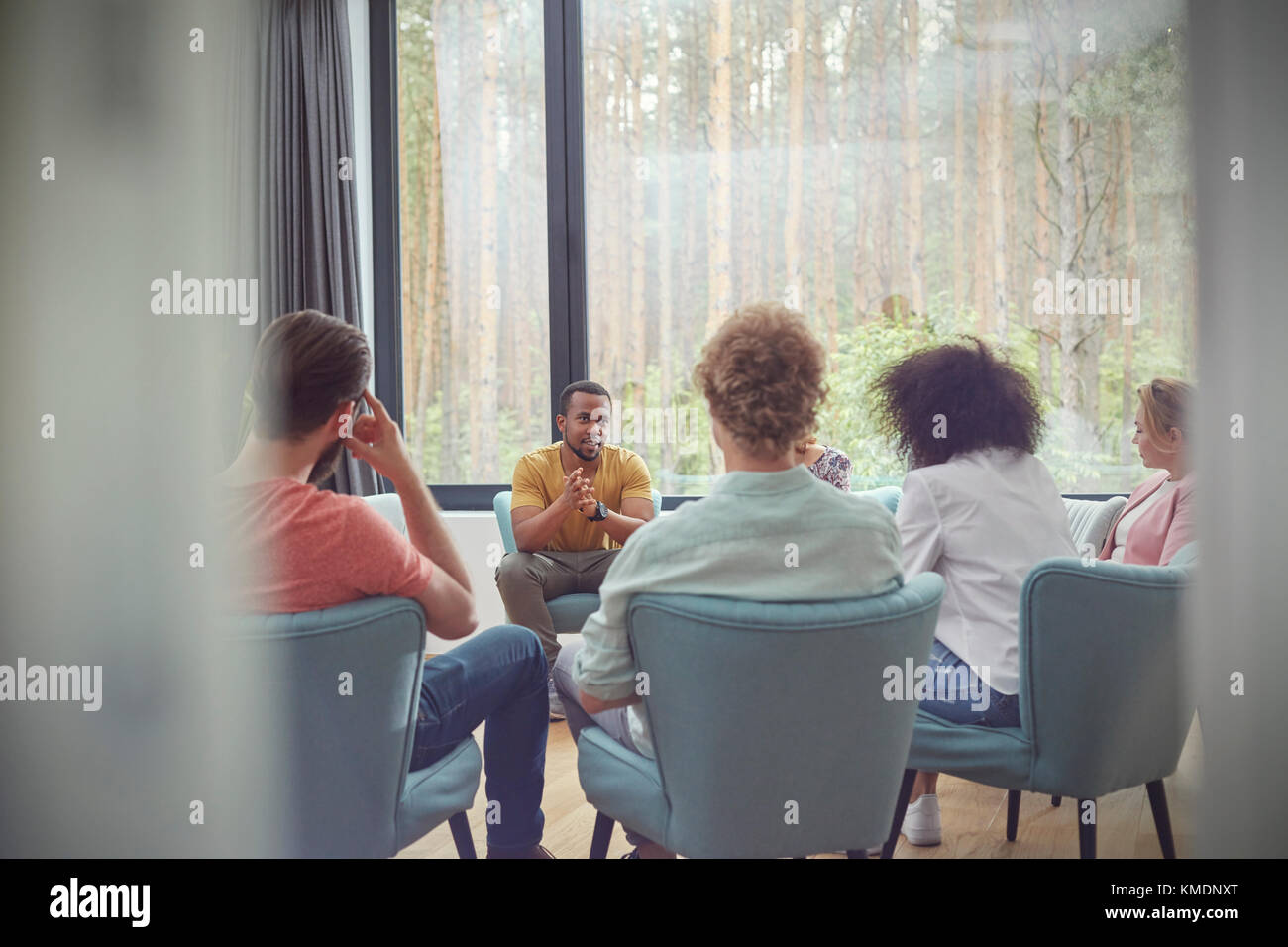 Man talking in group therapy session Stock Photo