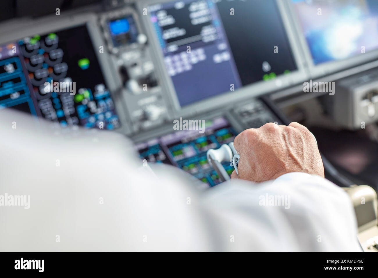 Pilot flying airplane in cockpit Stock Photo