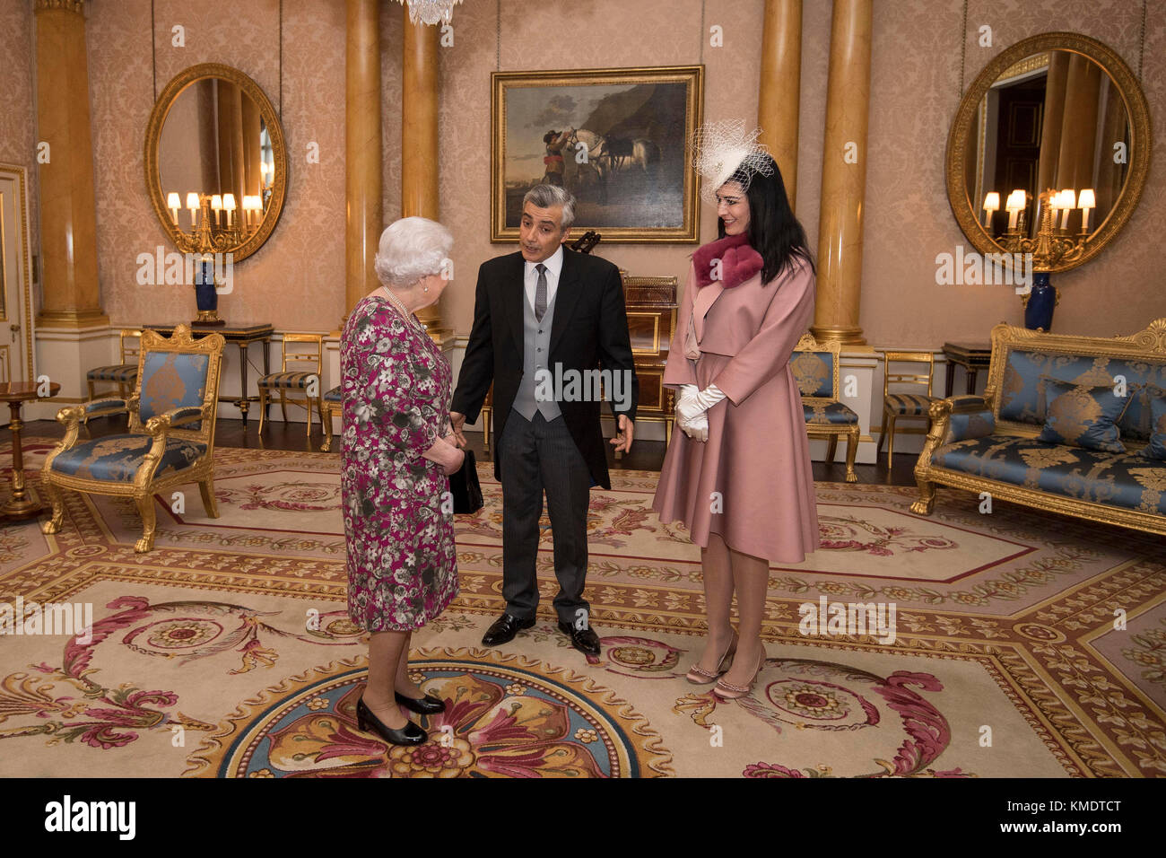 Queen Elizabeth II meets Mr Rami Mortada, the Ambassador of the Lebanese Republic, as he presents his Letter of Credence with his wife, Mrs Gamal Yehia, during a private audience at Buckingham Palace in central London. Stock Photo