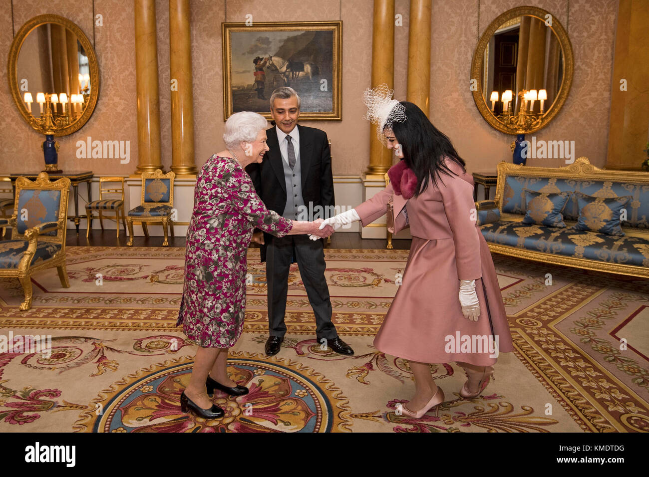 Queen Elizabeth II meets Mr Rami Mortada, the Ambassador of the Lebanese Republic, as he presents his Letter of Credence with his wife, Mrs Gamal Yehia, during a private audience at Buckingham Palace in central London. Stock Photo