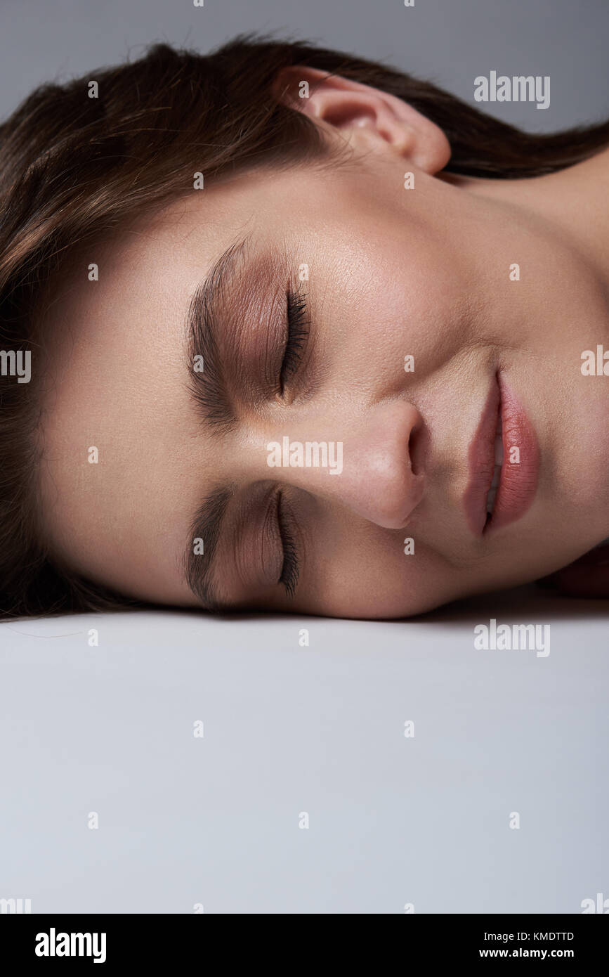 Sleeping young woman portrait close-up. Laying caucasian girl with close eyes Stock Photo