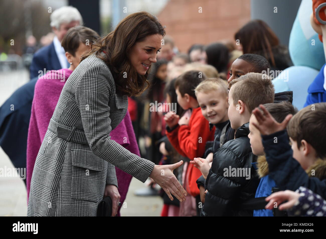 The Duchess of Cambridge greets well-wishers as she arrives for the Children's Global Media Summit at Manchester Central Convention Complex, which brings together creatives, technology innovators, policymakers, executives and thought leaders from around the globe to inform and redesign the future of media for this generation and explore the impact that digital technology will have in children's futures. Stock Photo