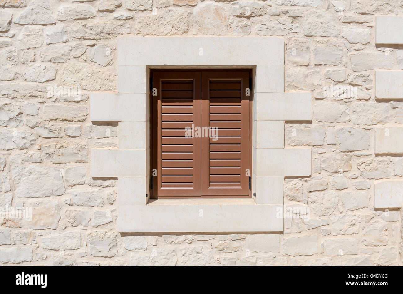 window with brown shutter and a natural stone wall Stock Photo - Alamy