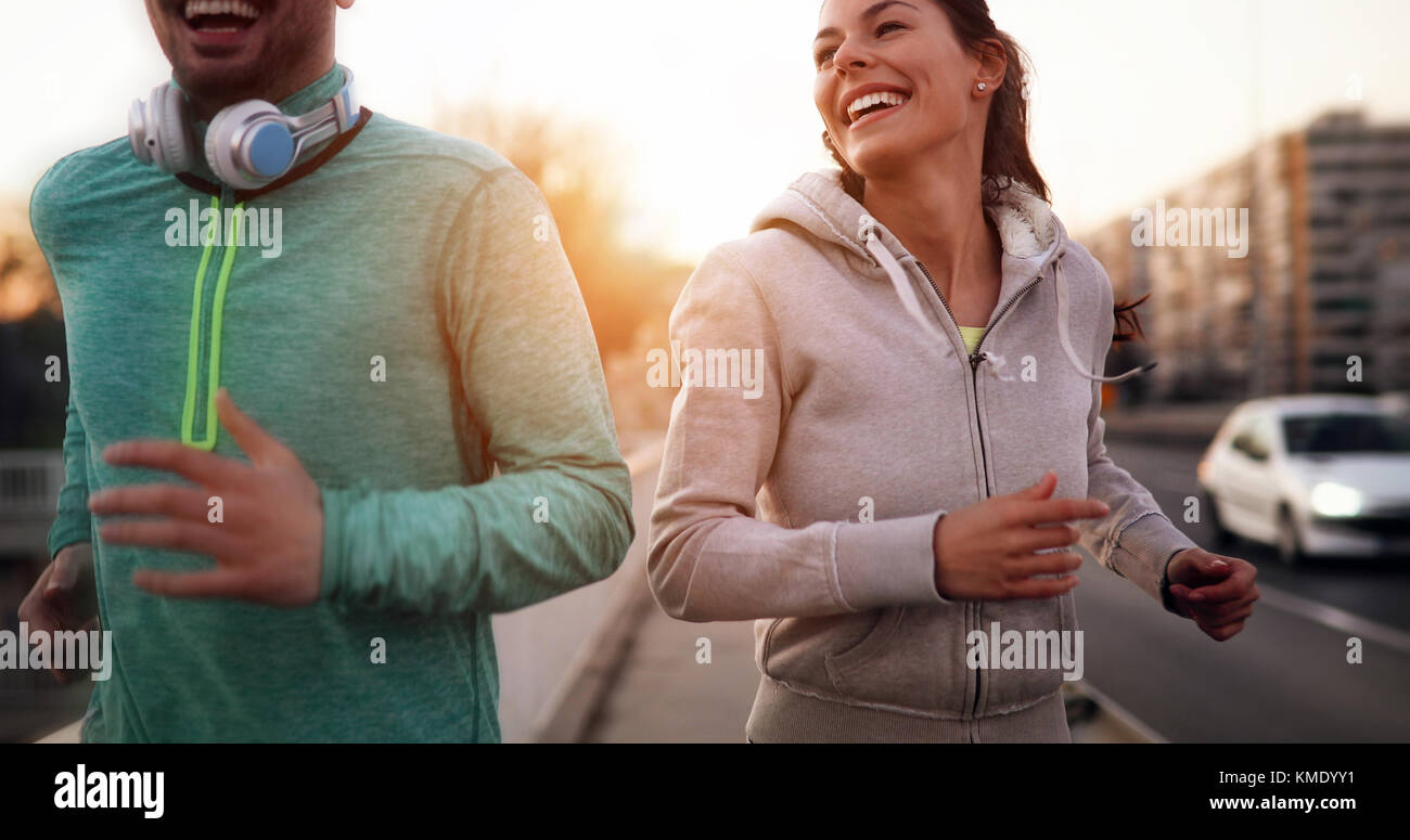 Young fitness couple running in urban area Stock Photo