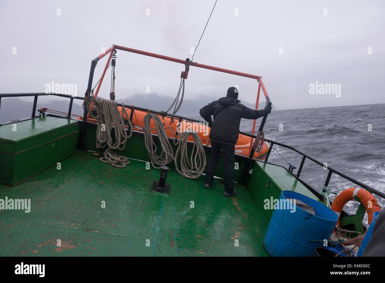 Boat navigating through the Straits of Magellan in heavy seas Stock Photo