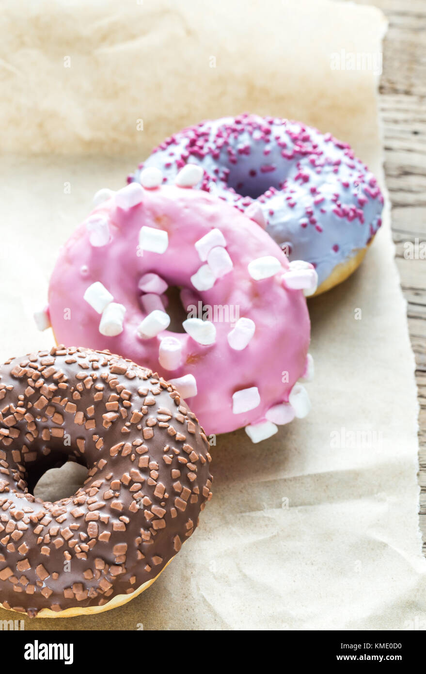 Colourful donuts on the baking paper Stock Photo - Alamy