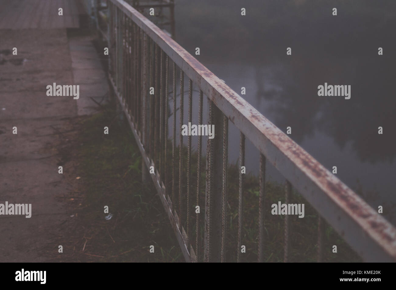 Railing constructions. Bridge over the river in misty morning. Stock Photo