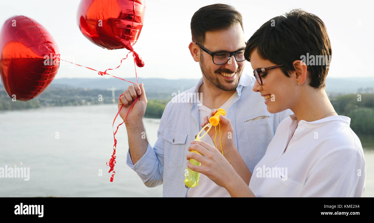 smiling couple in love with balloons on sunset Stock Photo - Alamy