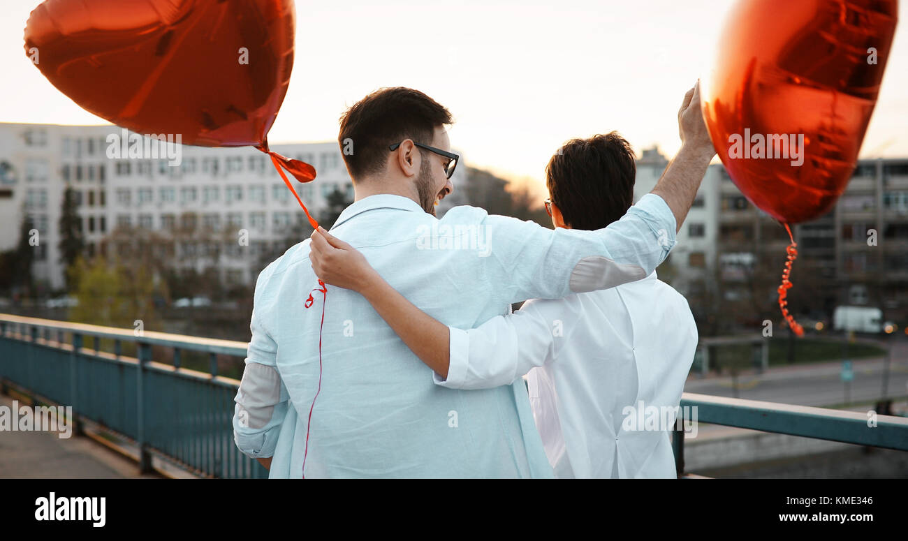 smiling couple in love with balloons on sunset Stock Photo - Alamy