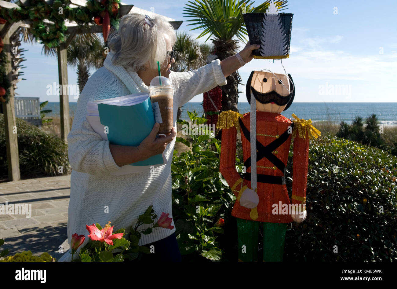 Senior woman setting up Christmas display at Myrtle Beach Gardens by the Sea South Carolina USA. Stock Photo