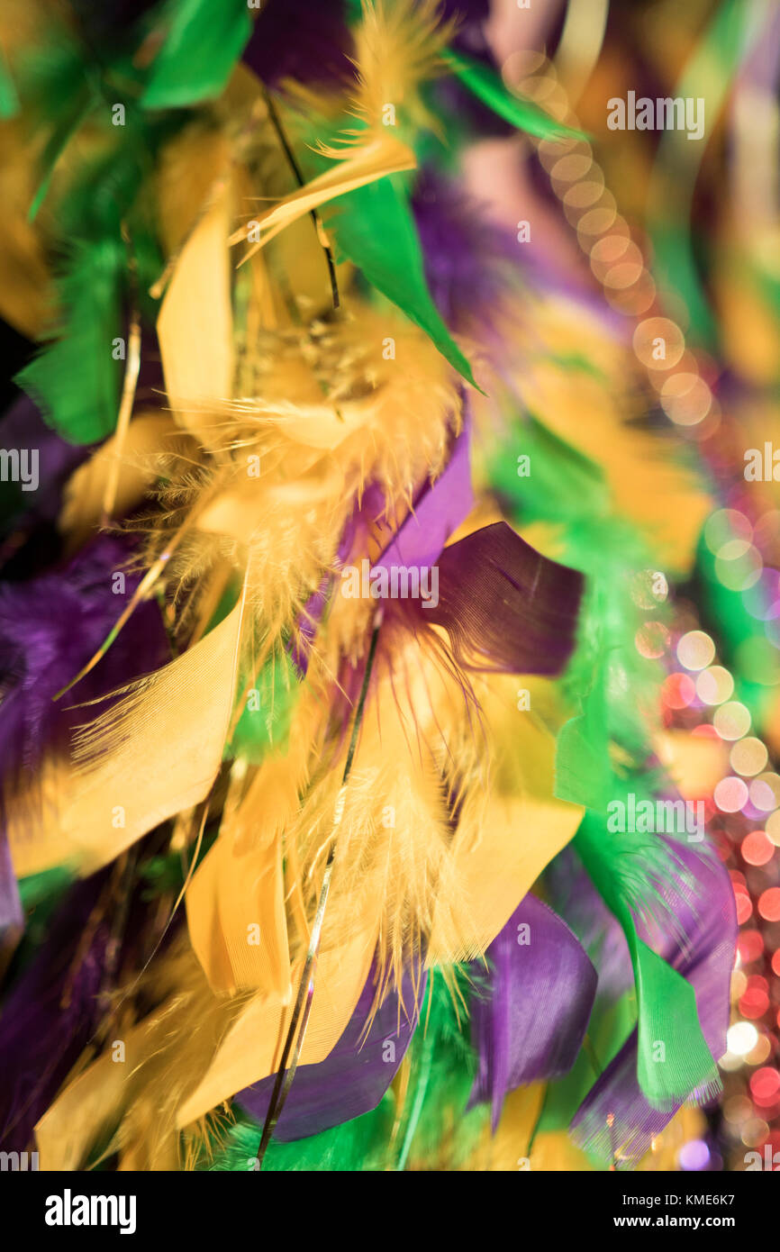 Green gold and purple Mardi Gras feather boa and beads Stock Photo