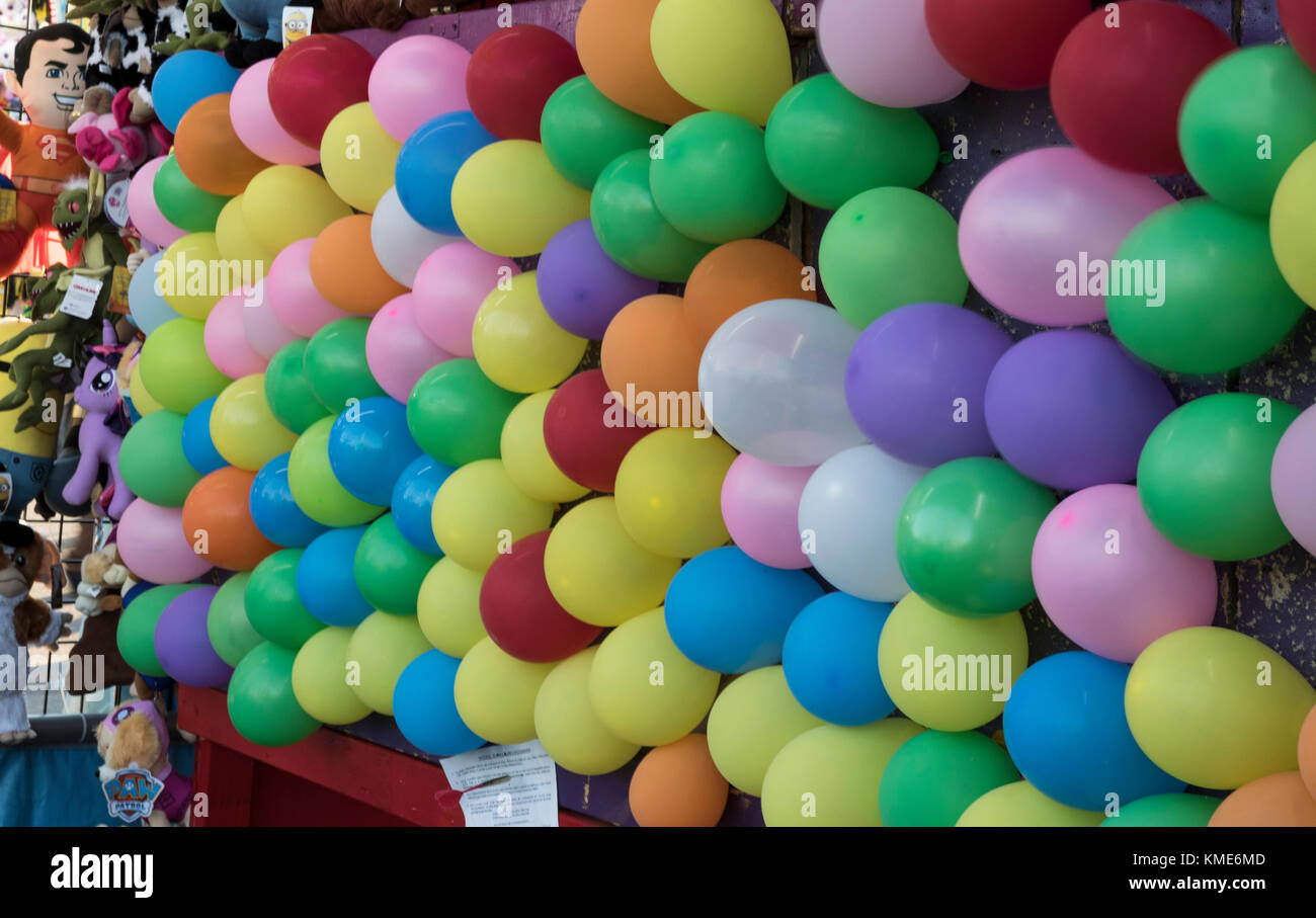 Pop the balloon dart game at a carnival or fair Stock Photo - Alamy