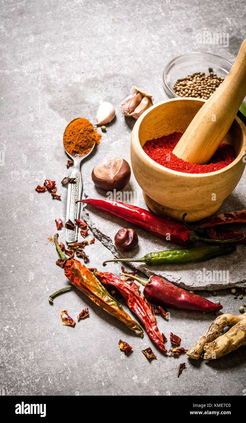 Spices - ground red pepper, garlic and coriander. On the stone table. Stock Photo