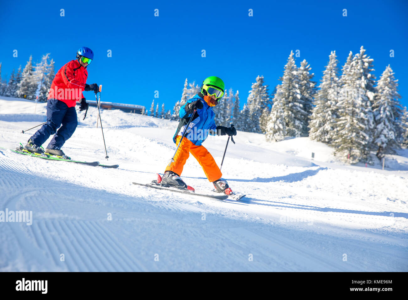 Happy little boy skiing with his father on ski holiday in Alps. Stock Photo