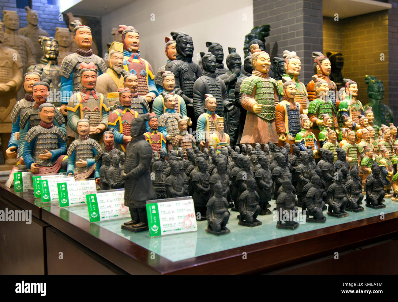 Catapulted into international tourism with the 1974 discovery of fields of buried life-size terracotta warriors,Xi'an today caters to a huge tourist trade with souvenir statues such as these,on sale in a state-run store.Xian is the capital of Shaanxi Province,People's Republic of China.It is the oldest of the Four Great Ancient Capitals,having held the position under several of the most important dynasties in Chinese history,including Western Zhou,Qin,Western Han,Sui,and Tang.Xi'an is the starting point of the Silk Road Stock Photo