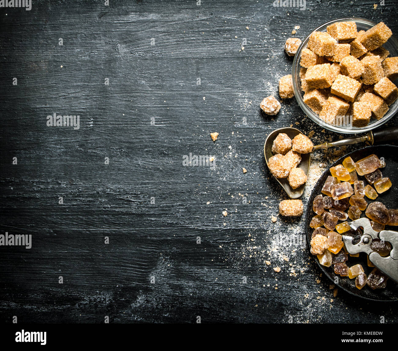 Brown cane sugar. On a black rustic background Stock Photo - Alamy