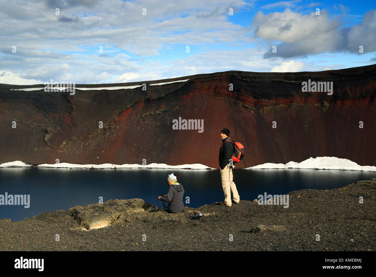Two tourists visiting Ljotipollur volcanic crater, Iceland Stock Photo