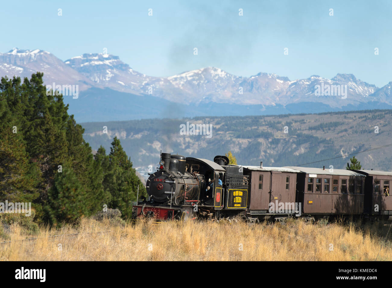 Locomotive crossing Old Patagonian Express railway with mountain range in background,Esquel,Chubut,Argentina Stock Photo