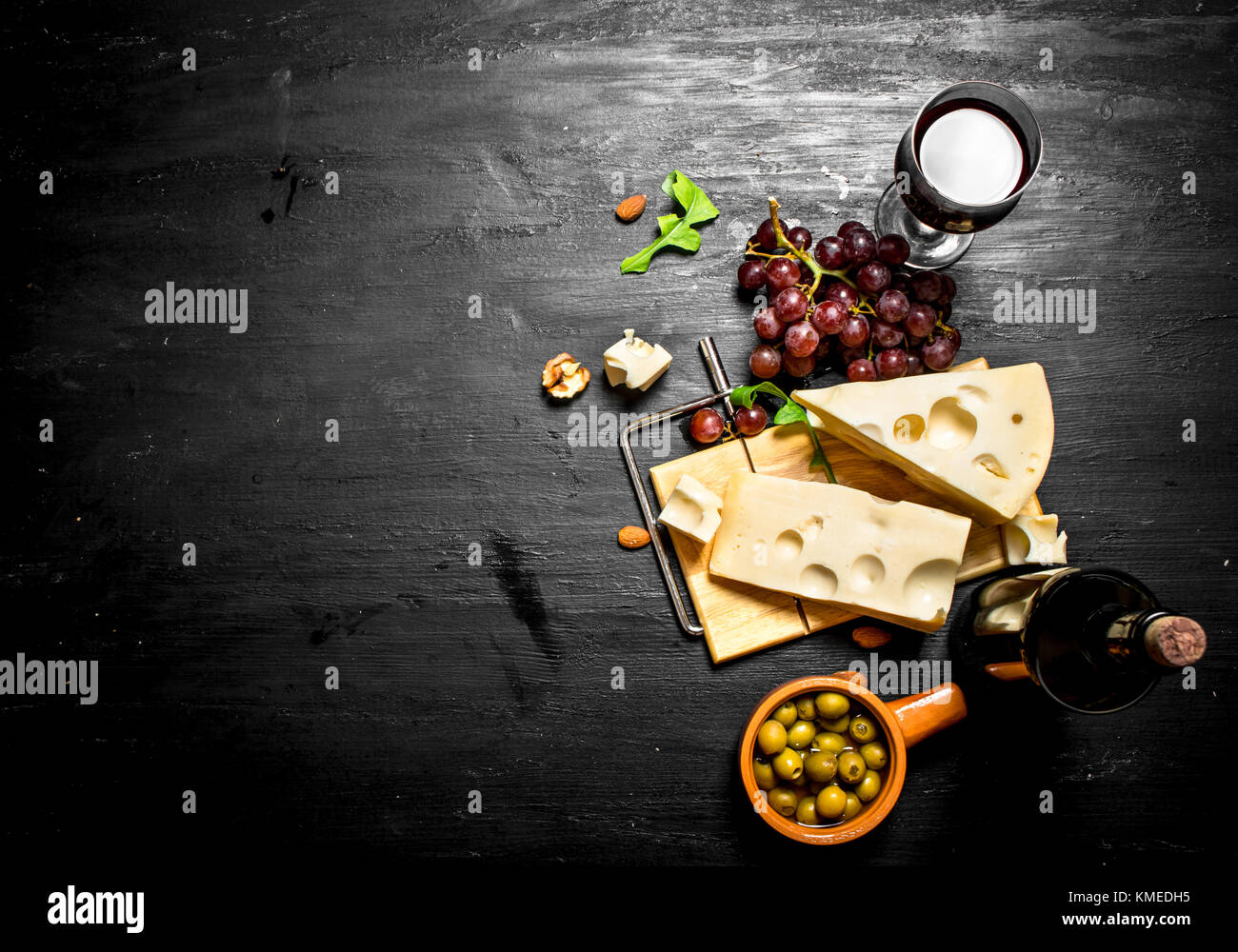 Red wine with a fragrant cheese , olives and almonds Stock Photo Alamy