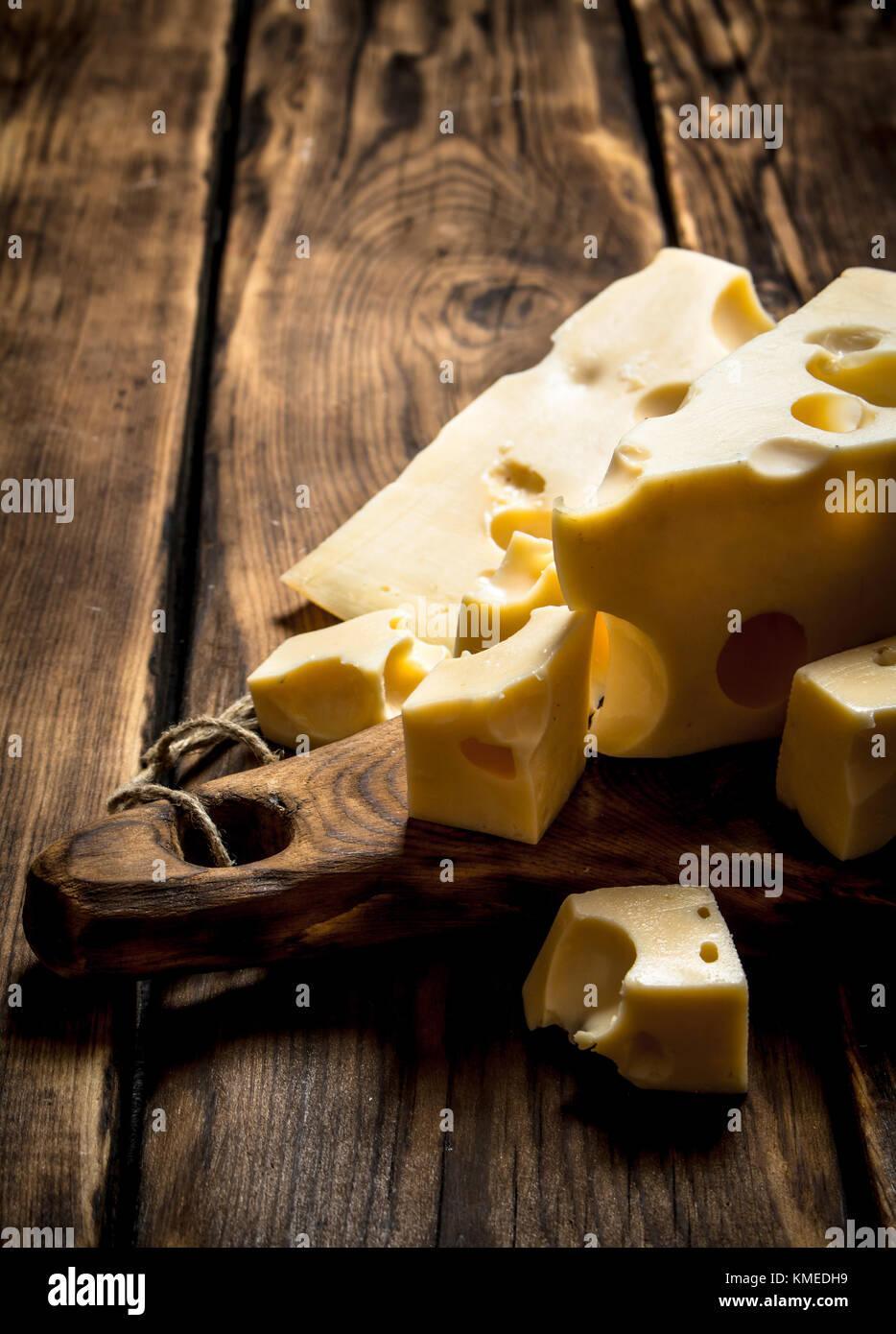 Pieces of fresh cheese on a cutting Board. Stock Photo