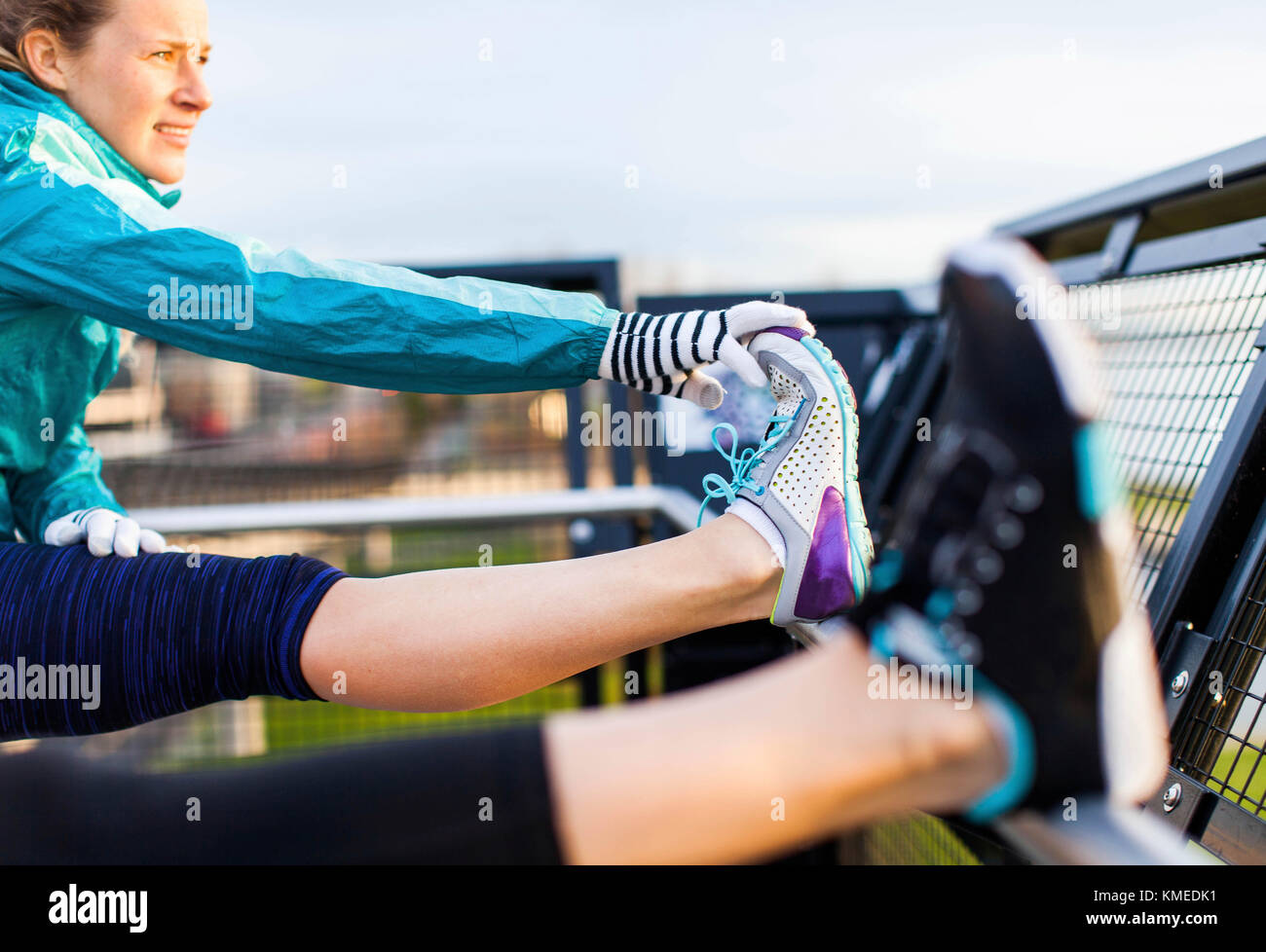 A female runner stretches her hamstring after a job near the Puget