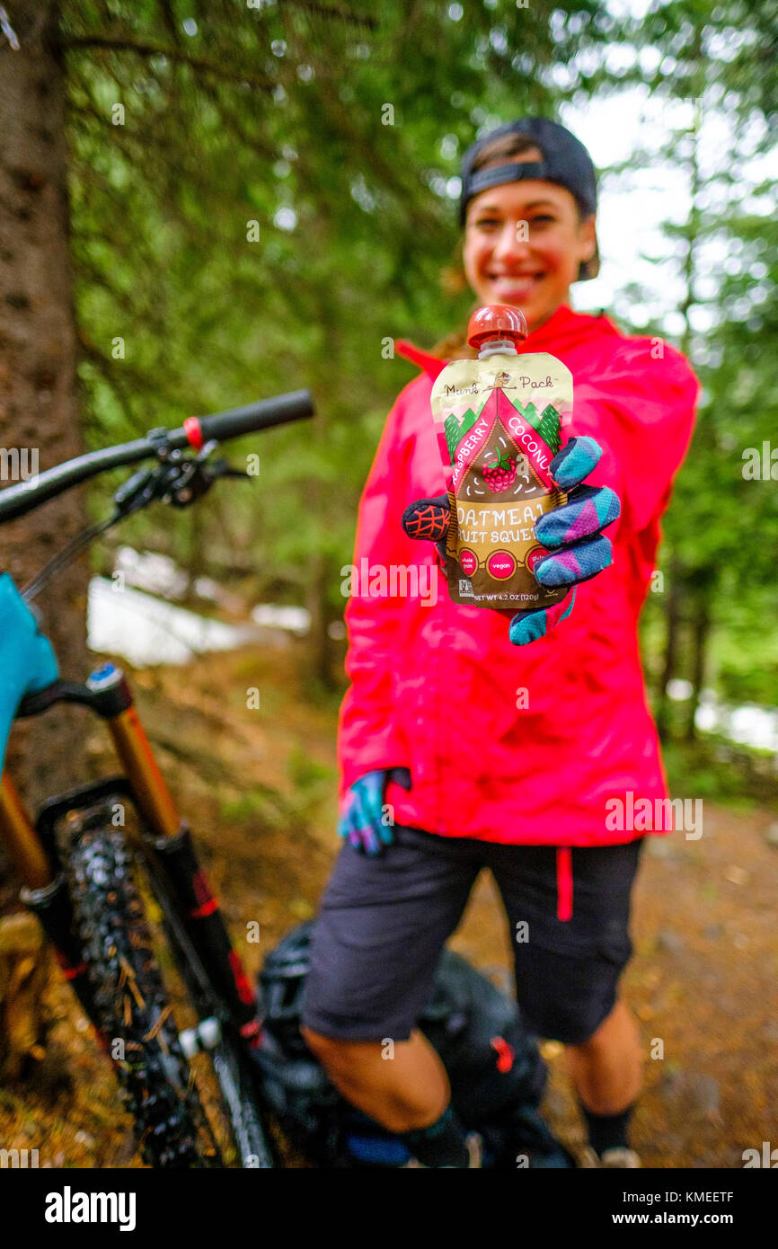 Portrait of female biker posing at Ice Lakes Trail with snack, Colorado, USA Stock Photo