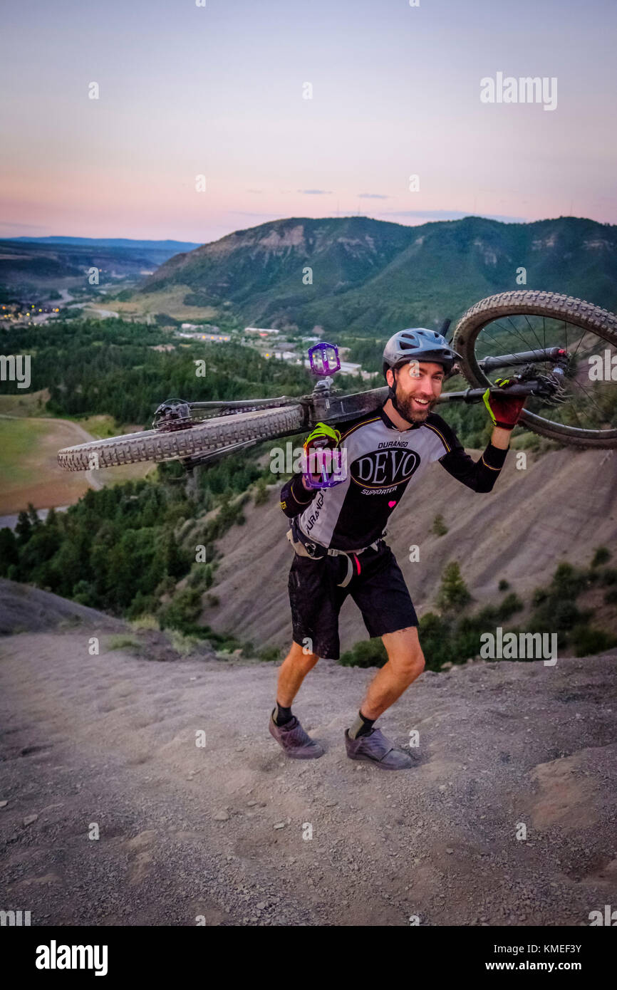 Male Mountain Biker in scenic landscape walks up Hogs back near Durango,Colorado,USA Stock Photo