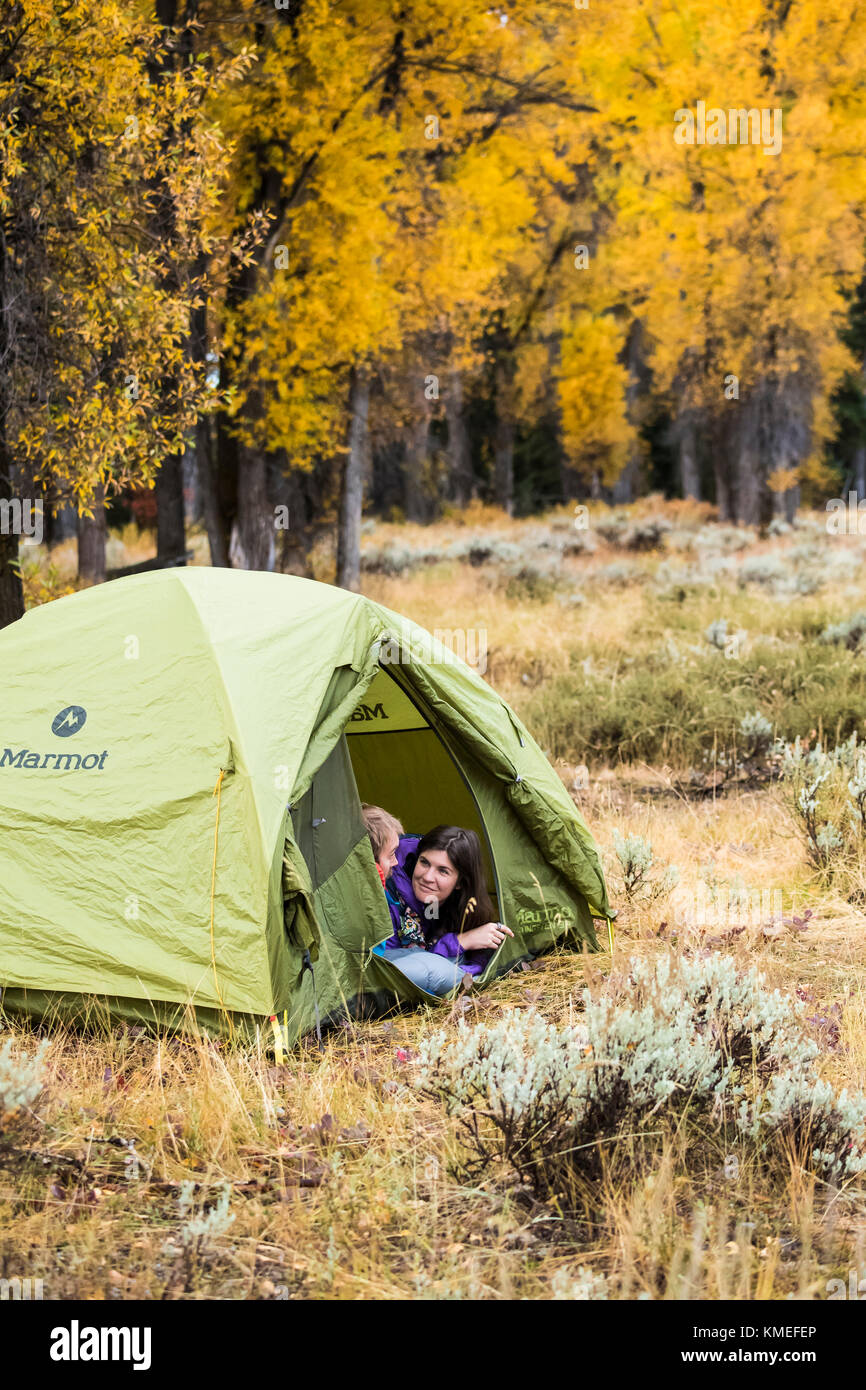 Couple sitting in tent while camping in autumn,Jackson,Wyoming,USA Stock Photo