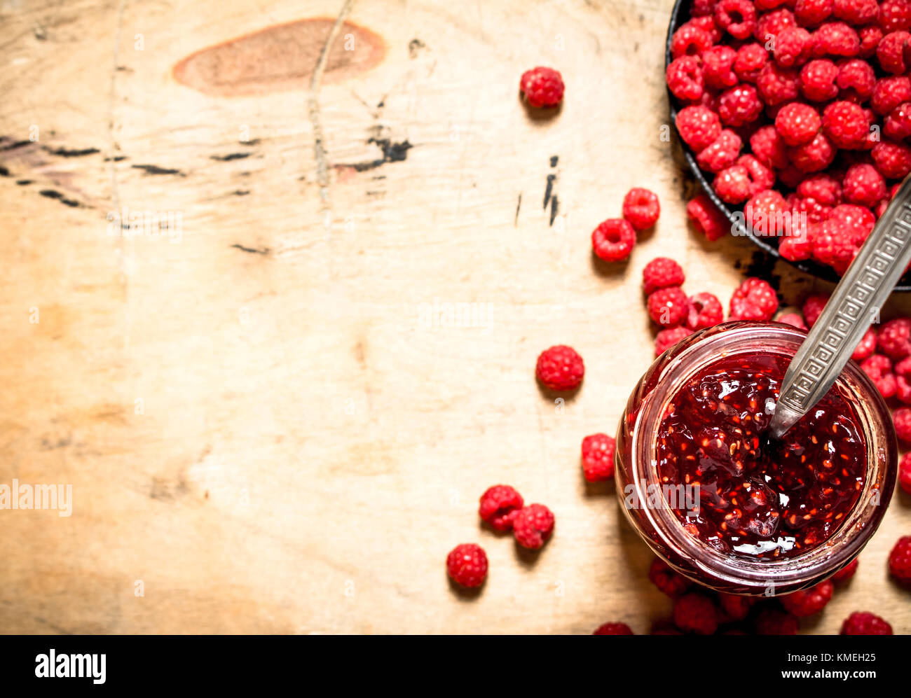 Sweet raspberry jam in jar with spoon. On a wooden table Stock Photo ...