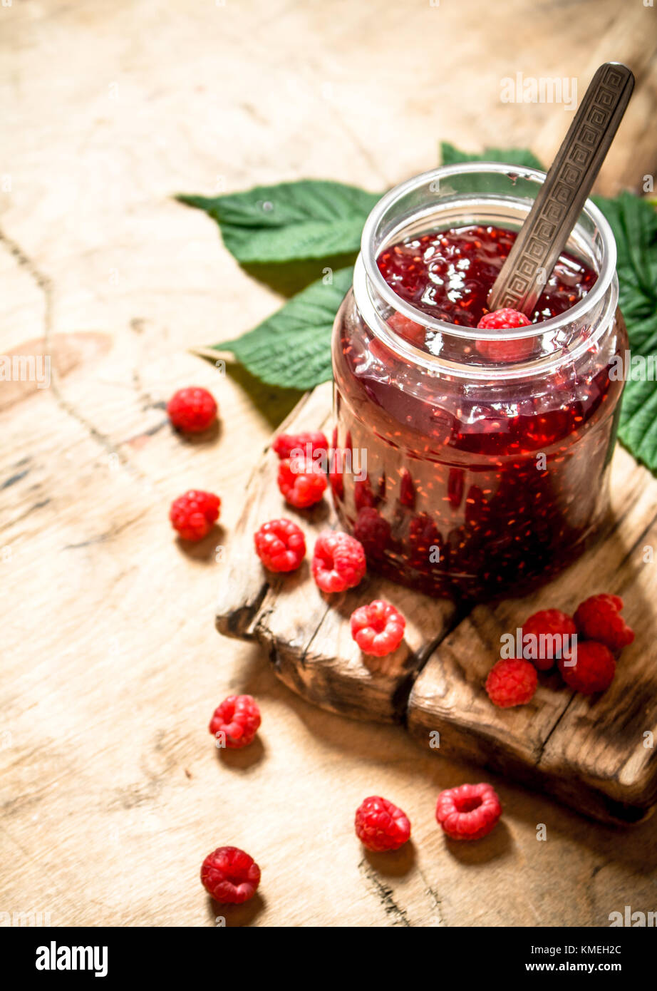 Sweet jam with raspberries. On a wooden table Stock Photo - Alamy