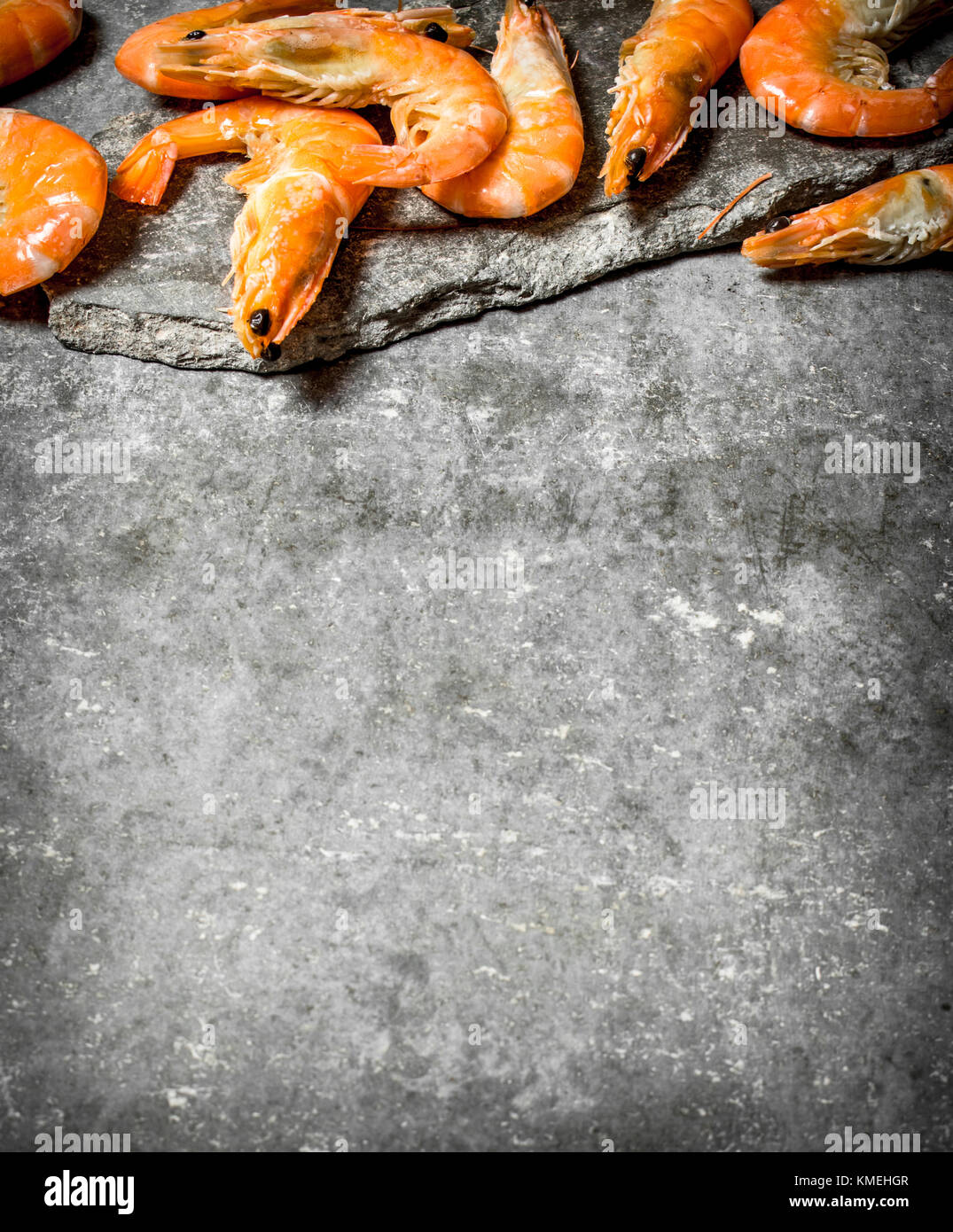 Raw big shrimp . On the stone table Stock Photo - Alamy