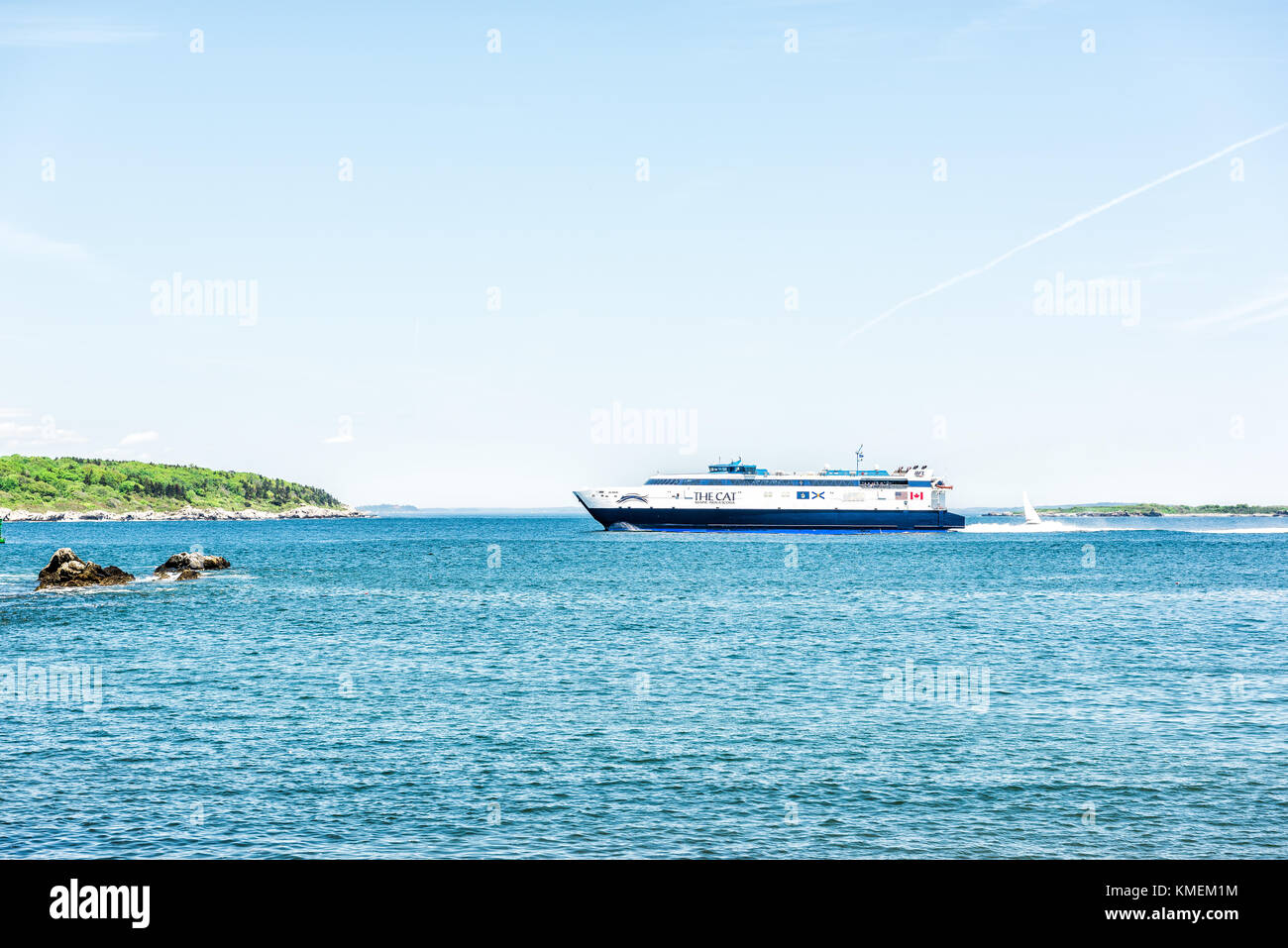Cape Elizabeth, USA - June 10, 2017: The Cat Cruise ship ferry boat by Portland Head Lighthouse in Fort Williams park in Maine during summer day Stock Photo