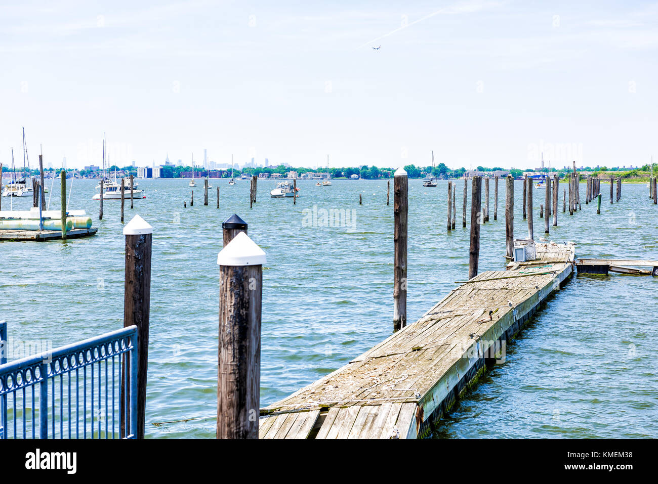 City Island harbor in Bronx, New York with boats and pier, Manhattan skyline or cityscape in distance Stock Photo