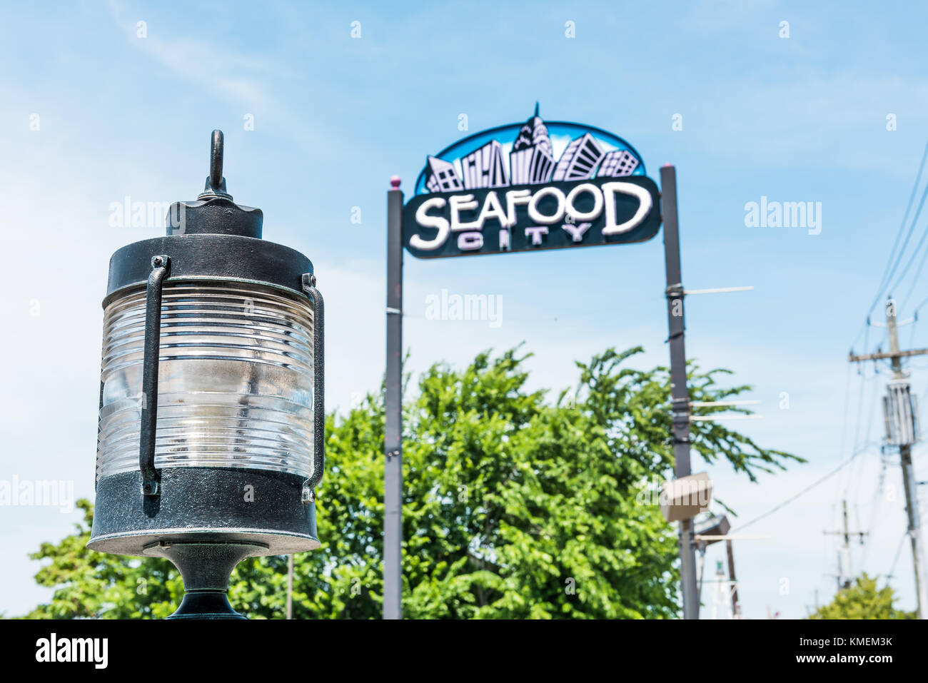 Bronx, USA - June 11, 2017: Restaurant sign in City Island called Seafood City on the water waterfront with lamp Stock Photo