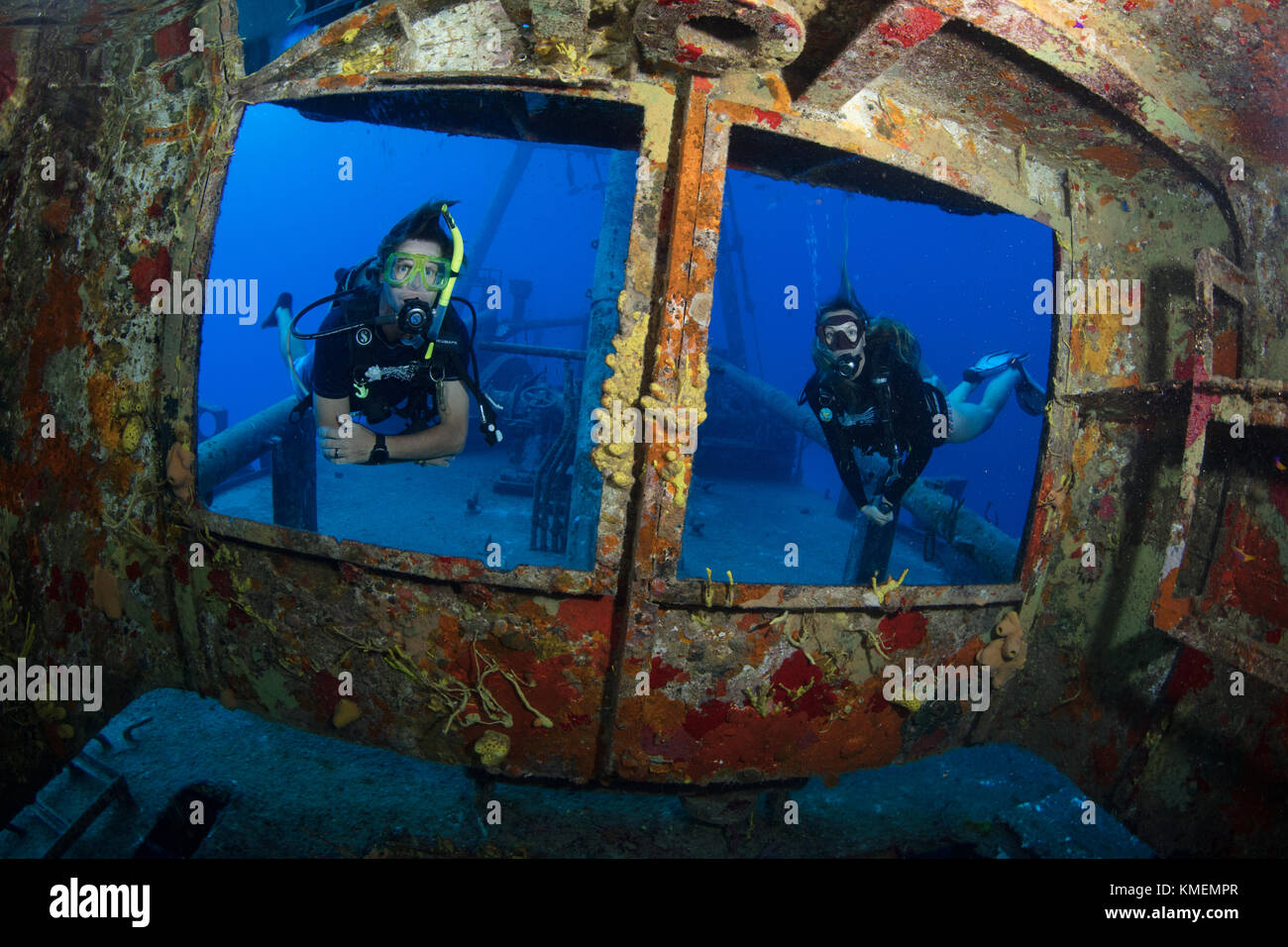 Divers peer through windows on bridge of USS Kittiwake Stock Photo