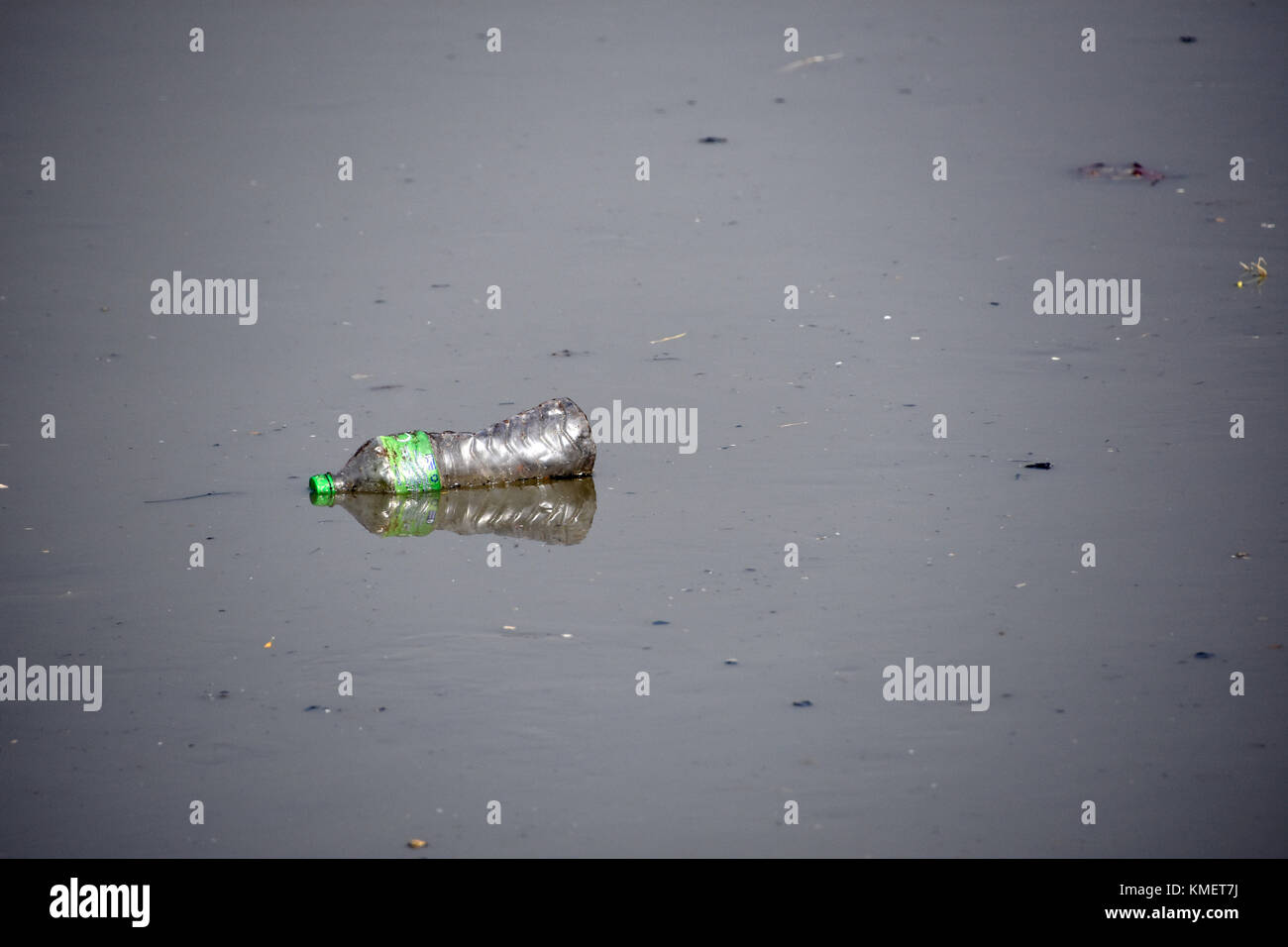 Plastic bottle floating down the river Stock Photo