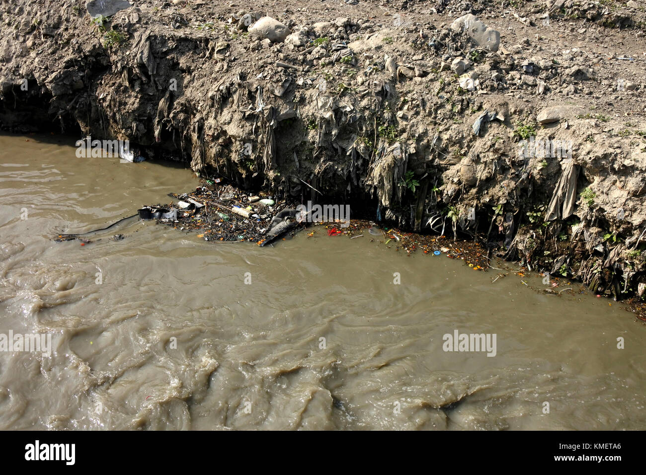 Mounts of plastic bags, dust and build up over many years in a river bed Stock Photo