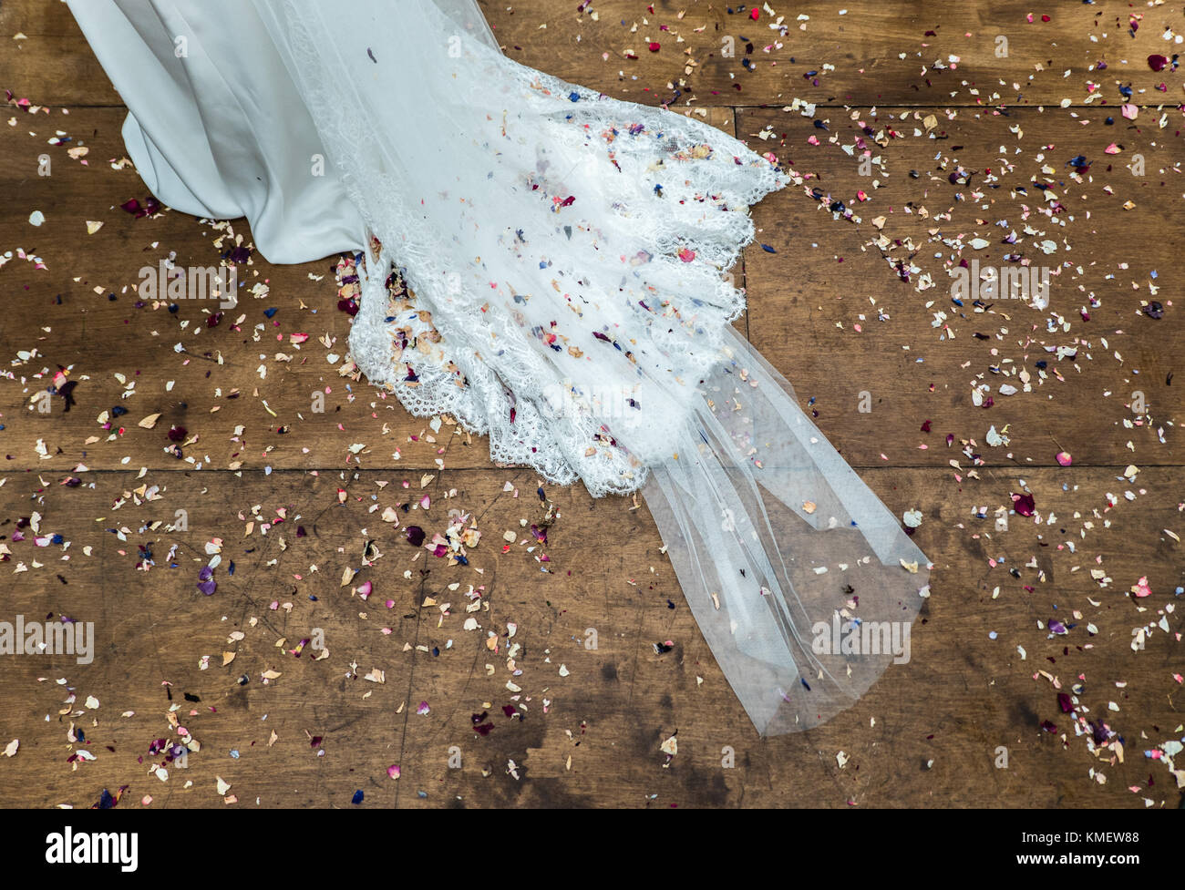 Confetti sprinkled on train of wedding dress Stock Photo