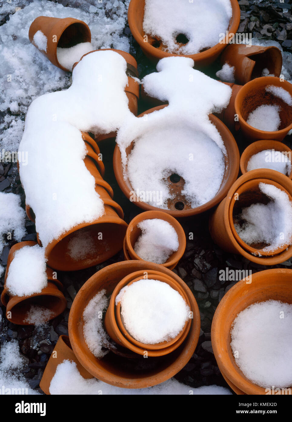Stacks of small, mainly hand made, terracotta flower pots left out over