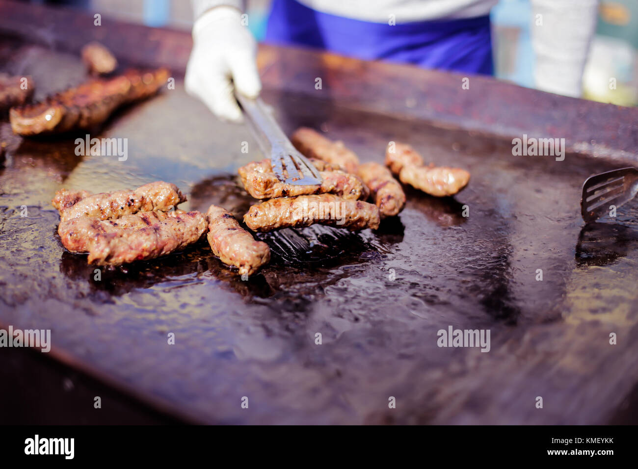 Man cooking meat on grill Stock Photo